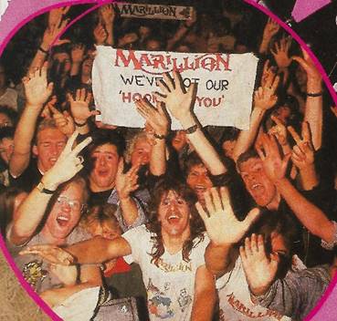 A group of people holding up a sign
Description automatically generated with low confidence